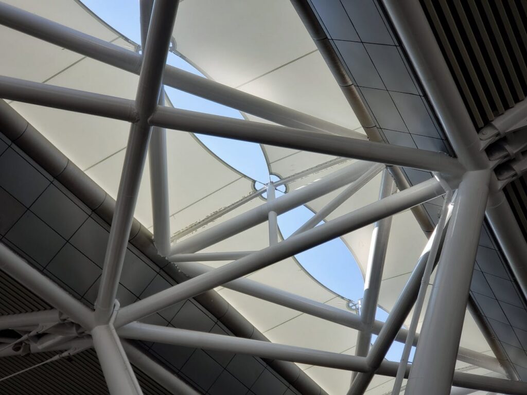 Low angle view of a modern geometric steel structure in Guangzhou, showcasing architectural design.